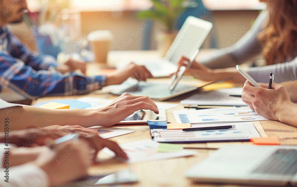 A group of people were working together around an office table, using laptops and papers to create marketing materials for their brand Generative AI A group of people were working together around an office table, using laptops and papers to create marketing materials for their brand Generative AI