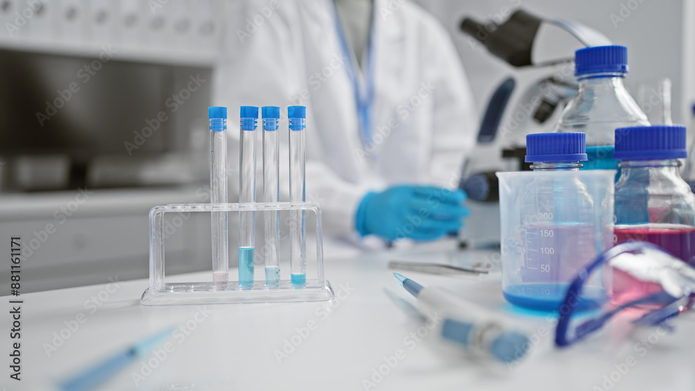 A focused scientist wearing a lab coat and gloves conducting experiments in a well-equipped laboratory A focused scientist wearing a lab coat and gloves conducting experiments in a well-equipped laboratory