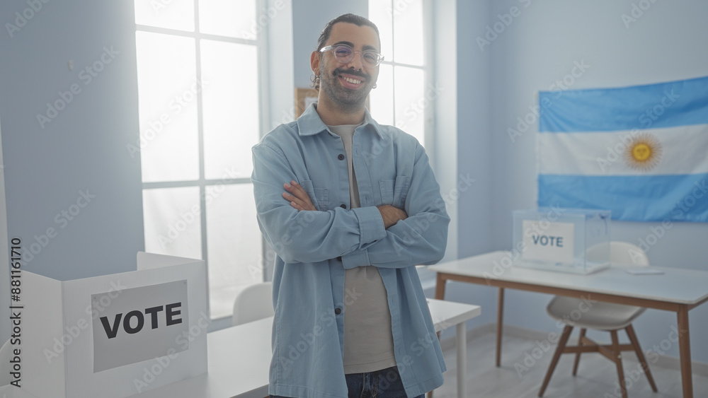 Young man with moustache standing with arms crossed in an indoor electoral setting in argentina, featuring an argentinian flag, vote boxes, and bright daylight. Young man with moustache standing with arms crossed in an indoor electoral setting in argentina, featuring an argentinian flag, vote boxes, and bright daylight.
