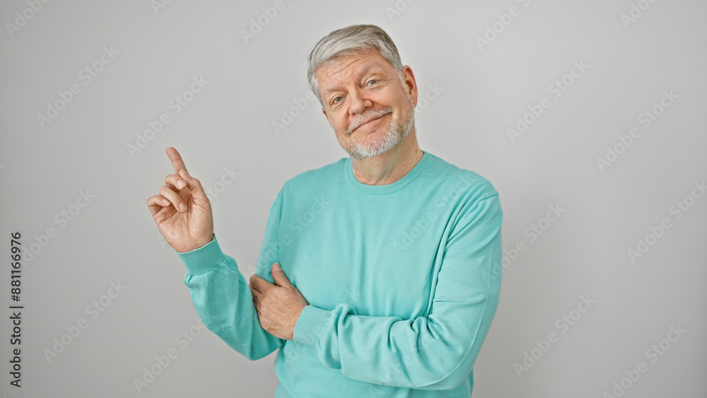 Smiling senior man in turquoise sweater isolated on white background pointing with index finger Smiling senior man in turquoise sweater isolated on white background pointing with index finger