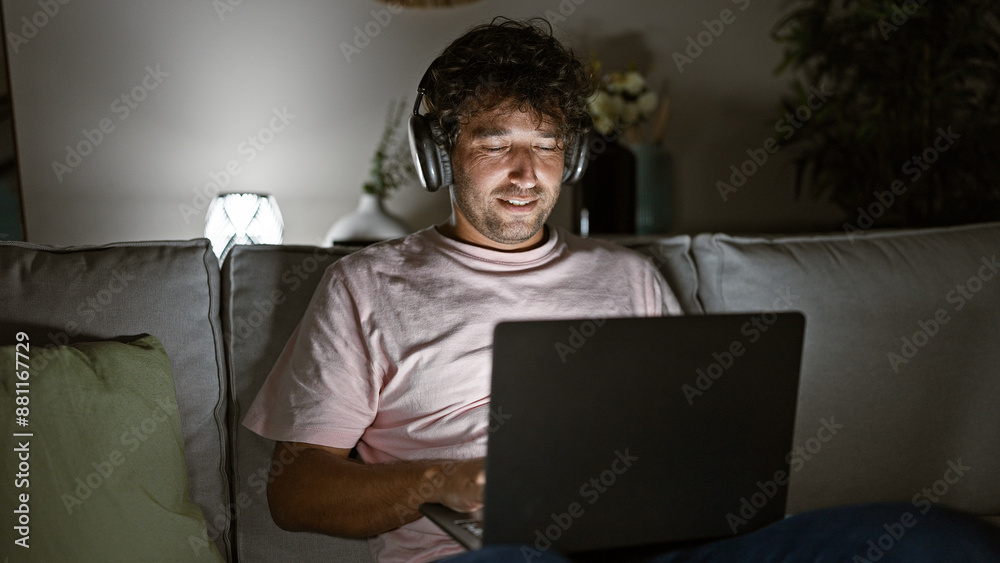 Handsome hispanic man with headphones using laptop at home, depicting remote work or leisure. Handsome hispanic man with headphones using laptop at home, depicting remote work or leisure.