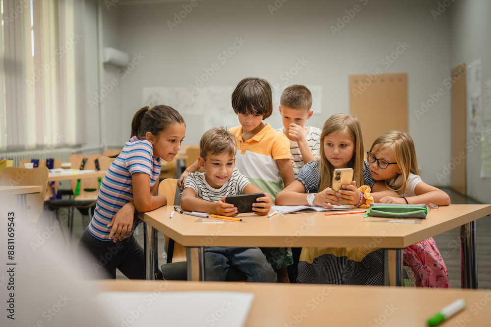 Young students use cellphone for video games on a break at school Young students use cellphone for video games on a break at school