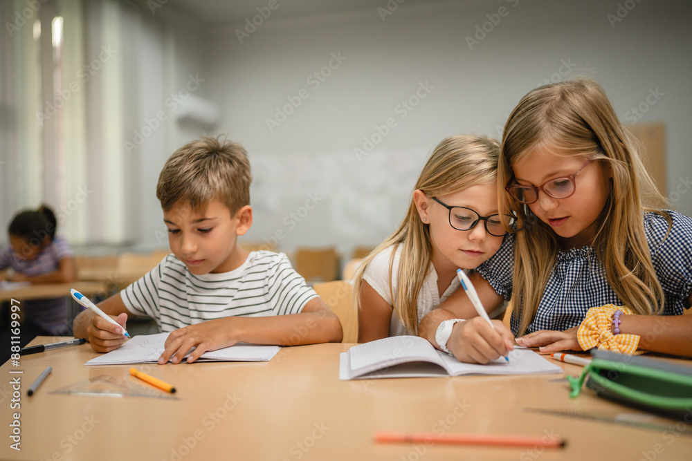 Young friends student do tasks and write on notebook on the class Young friends student do tasks and write on notebook on the class