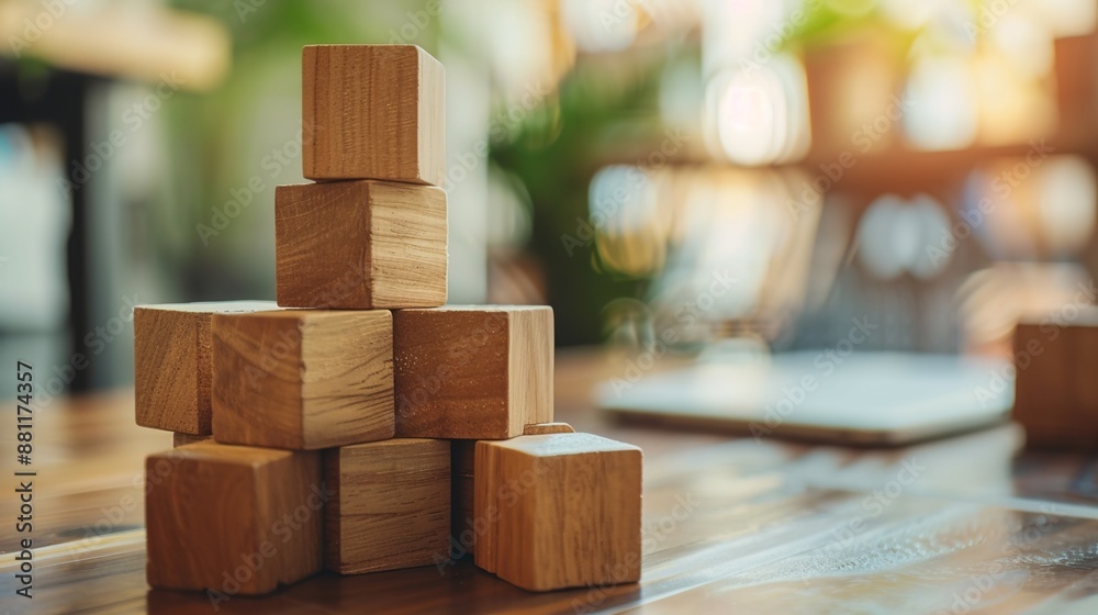 Business growth concept portrayed by wooden blocks on a desk with blurred elements Business growth concept portrayed by wooden blocks on a desk with blurred elements