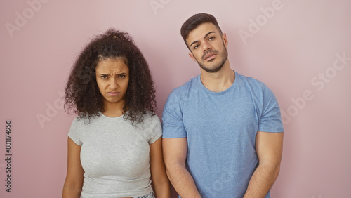 Quadro su tela Unhappy couple standing against a plain pink wall showcasing relationship issues