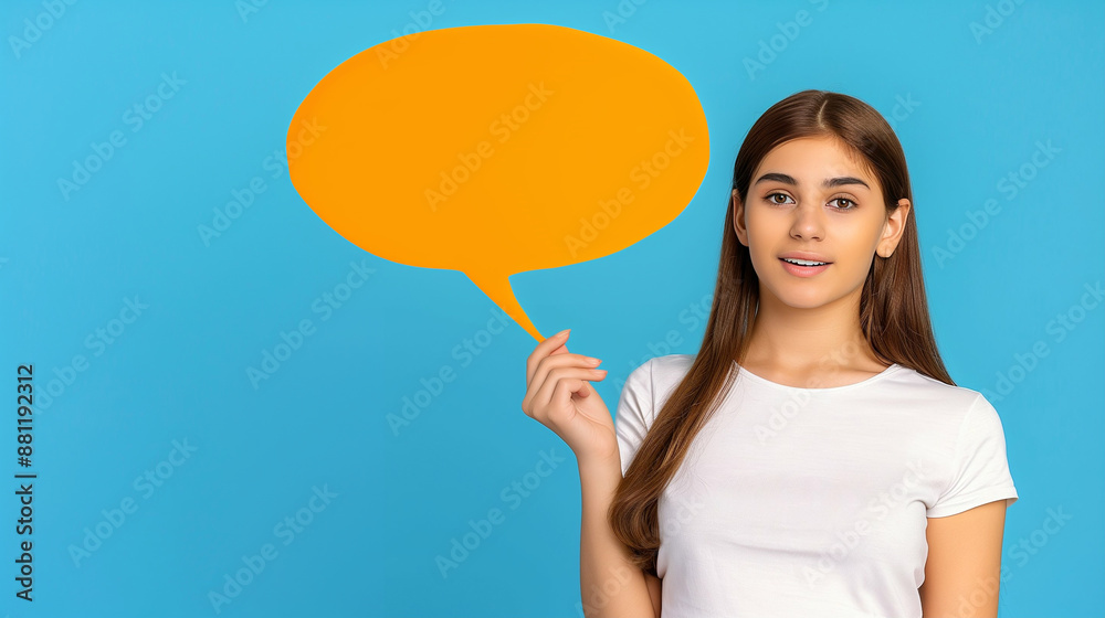 Young Woman Holding Orange Speech Bubble on Blue Background. Conceptual Communication and Creative Message Display Young Woman Holding Orange Speech Bubble on Blue Background. Conceptual Communication and Creative Message Display
