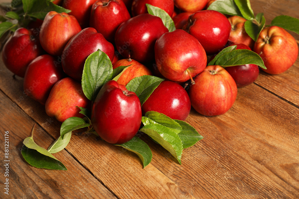 Fresh ripe red apples with leaves on wooden table. Space for text Fresh ripe red apples with leaves on wooden table. Space for text