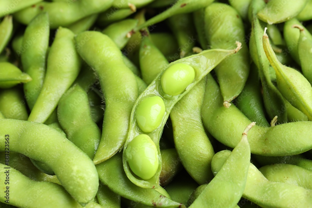 Fresh edamame pods with soybeans as background, above view Fresh edamame pods with soybeans as background, above view