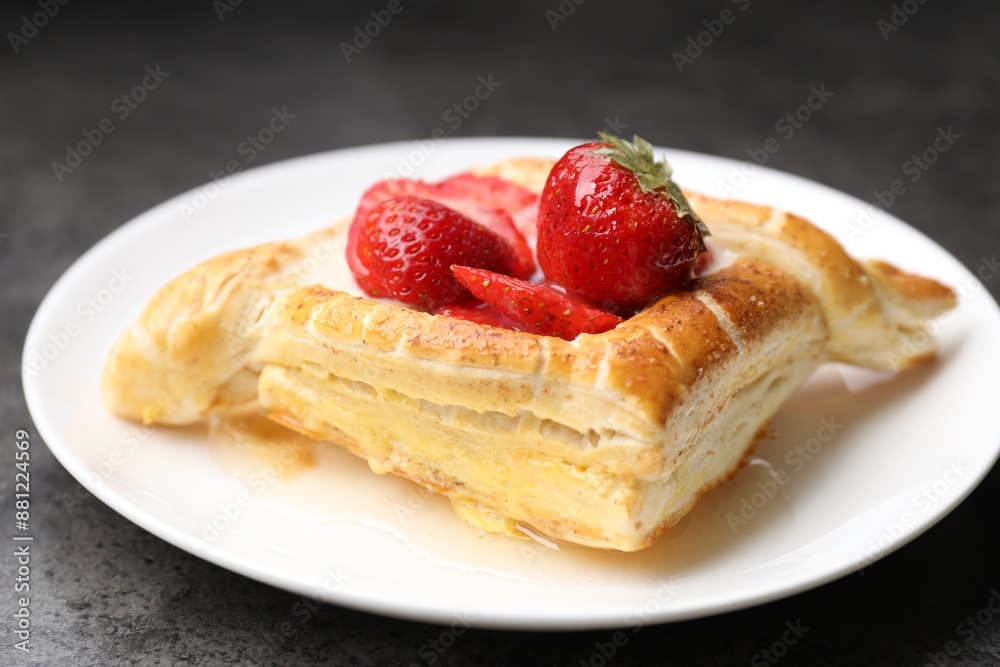 Tasty puff pastry with strawberries on grey table, closeup Tasty puff pastry with strawberries on grey table, closeup