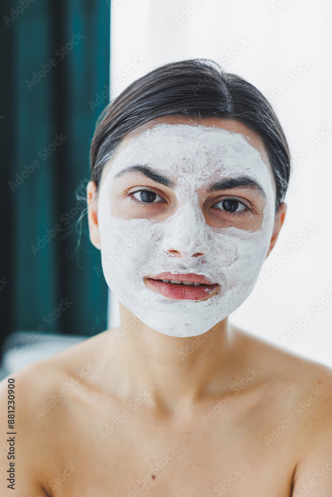 Close-up of a woman's face with a white mask on her face. Mask on the face of your client in the beauty salon. Skin cleansing and moisturizing concept. Facial skin care. Close-up of a woman's face with a white mask on her face. Mask on the face of your client in the beauty salon. Skin cleansing and moisturizing concept. Facial skin care.