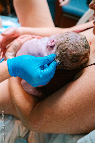 Nurse admires newborn hair after hospital birth