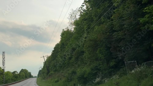 Driving by power lines on rural midwest country road
