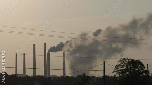 Midwest factory smoke stacks with birds on wires