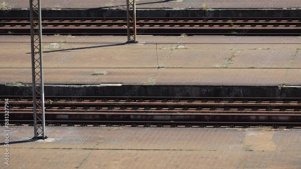 Establishing shot of empty train old and rusty tracks on railway station. Area appears to be abandoned Establishing shot of empty train old and rusty tracks on railway station. Area appears to be abandoned