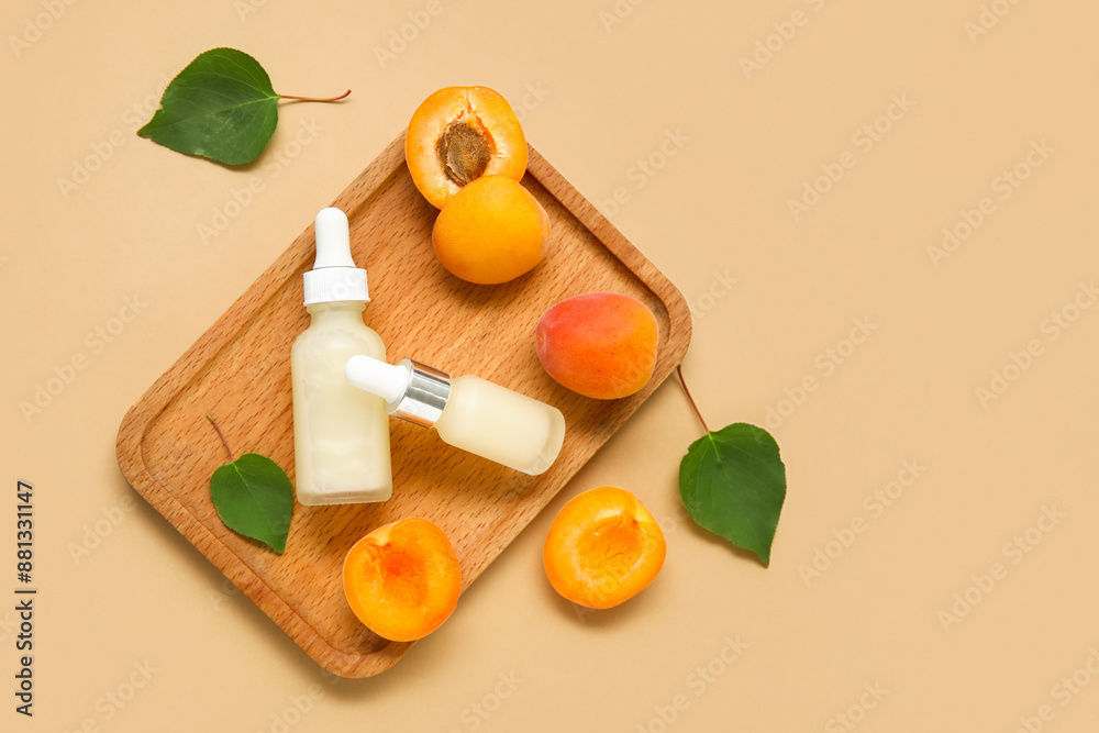 Bottles of cosmetic oil with fresh apricots on brown background Bottles of cosmetic oil with fresh apricots on brown background