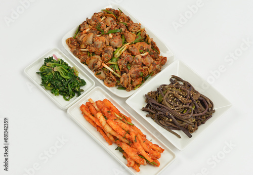 Close-up of seasoned holiday food like deodeok roots, spinach, bracken and cockles on piece dish and white floor, South Korea
 photo