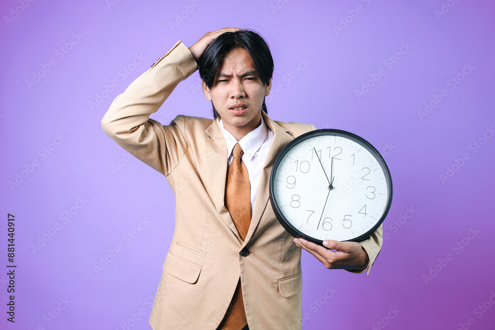 Worried Of Young Asian Businessman Touching His Head While Holding Clock Isolated On Purple Background
Worried Of Young Asian Businessman Touching His Head While Holding Clock Isolated On Purple Background