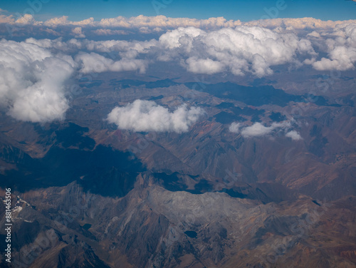 View From the Airplane of the Rocky Mountains Over Peru with a Blue Sky and Clouds as a Background