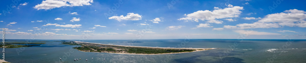 Panoramic view of Jones Beach with boats dotting the clear blue waters. Showcases the harmonious blend of marine activity and serene beach landscapes. Panoramic view of Jones Beach with boats dotting the clear blue waters. Showcases the harmonious blend of marine activity and serene beach landscapes.