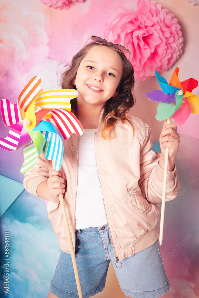 Happy teenage girl portrait with two kids pinwheel toys Happy teenage girl portrait with two kids pinwheel toys
