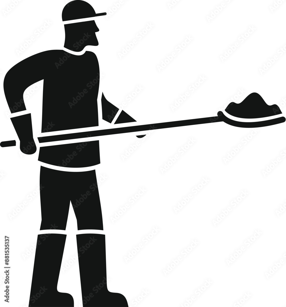 Construction worker wearing boots and gloves holding a shovel with building material Construction worker wearing boots and gloves holding a shovel with building material