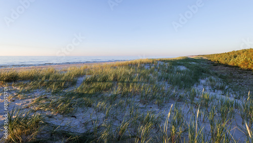 Obraz na płótnie A beautiful beach on the Baltic Sea with dunes covered with grass. Golden hour. Slajszewo, Poland w salonie