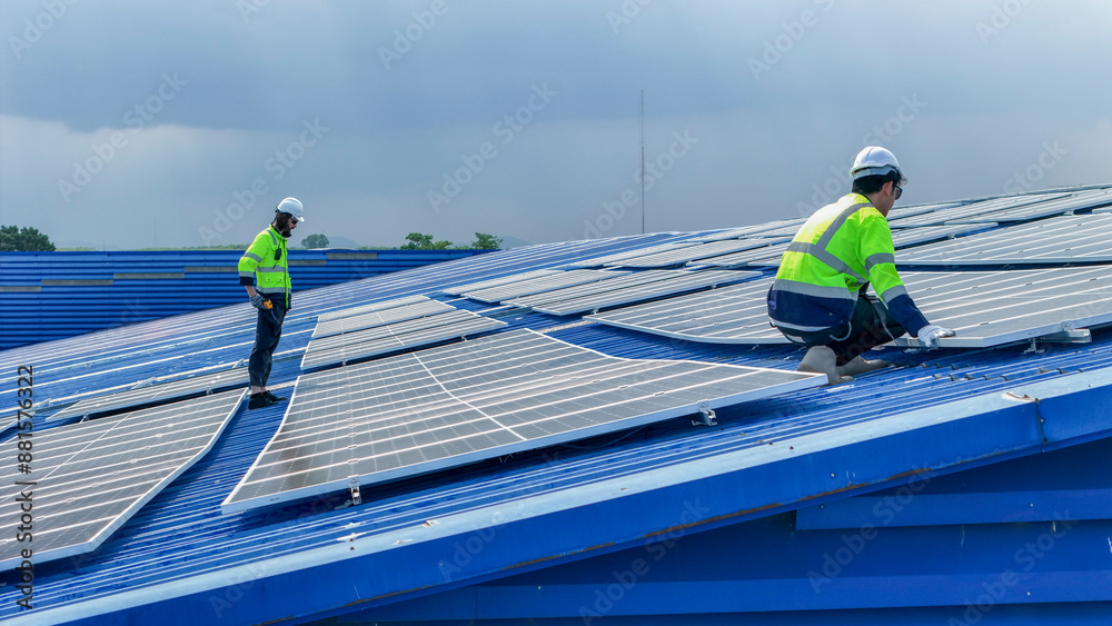 Worker Technicians are working to construct solar panels system on roof. Installing solar photovoltaic panel system. Men technicians walking on roof structure to check photovoltaic solar modules. Worker Technicians are working to construct solar panels system on roof. Installing solar photovoltaic panel system. Men technicians walking on roof structure to check photovoltaic solar modules.
