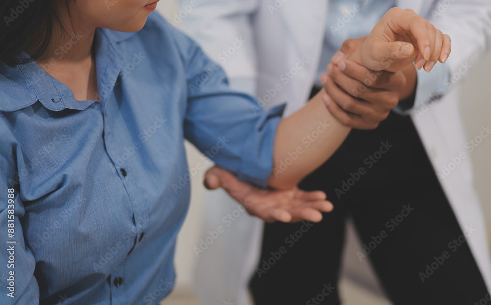 Obraz premium Doctor or Physiotherapist working examining treating injured arm of athlete male patient, stretching and exercise, Doing the Rehabilitation therapy pain in clinic.