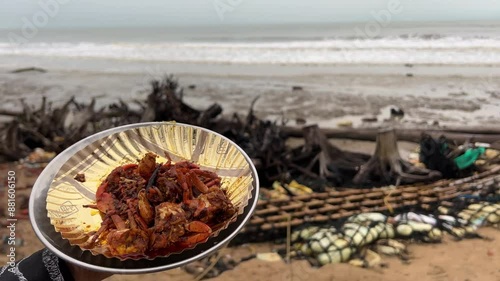 Red crab prepared with spicy red sauce in a local beach in India photo