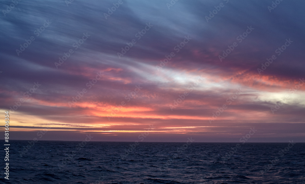 Colourful sunset over the sea, with purple and yellow sky, and calm water. Colourful sunset over the sea, with purple and yellow sky, and calm water.