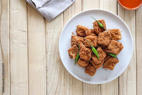 Sumedang tofu (tahu sumedang) on a wooden table. Perfect for recipe, article, catalogue, or any commercial purposes. photo