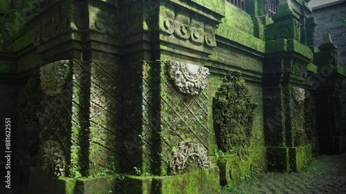 Old Built Structure With Mossy Carvings In Alas Harum Bali In Tegallalang, Indonesia. Jungle Temple. closeup, arc shot