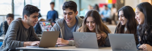 Wallpaper Mural Students are collaborating on laptops in a university campus common area. They are engaging in teamwork, discussion, and peer learning, focusing on academic projects and assignments Torontodigital.ca