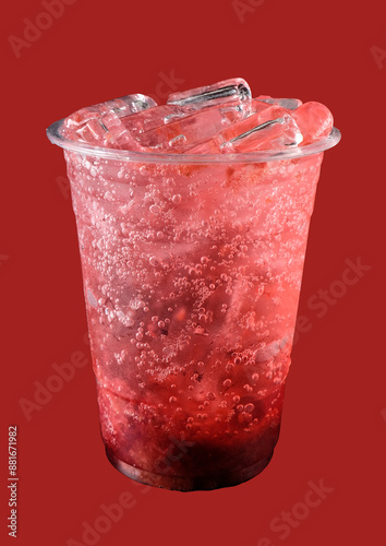 Strawberry juice with soda and ice in plastic glasses isolated. On red background. 