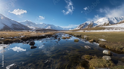 Panoramic view of a valley during the spring thaw, streams swollen with melting snow, the landscape waking from its winter sleep.