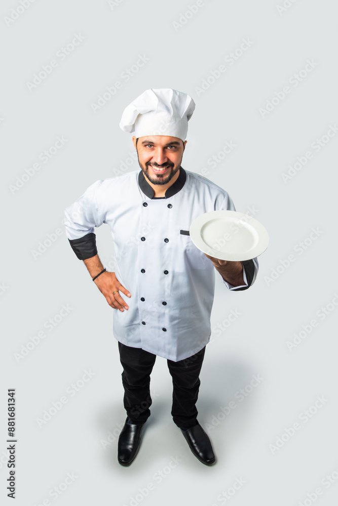 Smiling Asian Indian chef or professional cook with terracotta pot, plate or bowl, High angle top view. Smiling Asian Indian chef or professional cook with terracotta pot, plate or bowl, High angle top view.