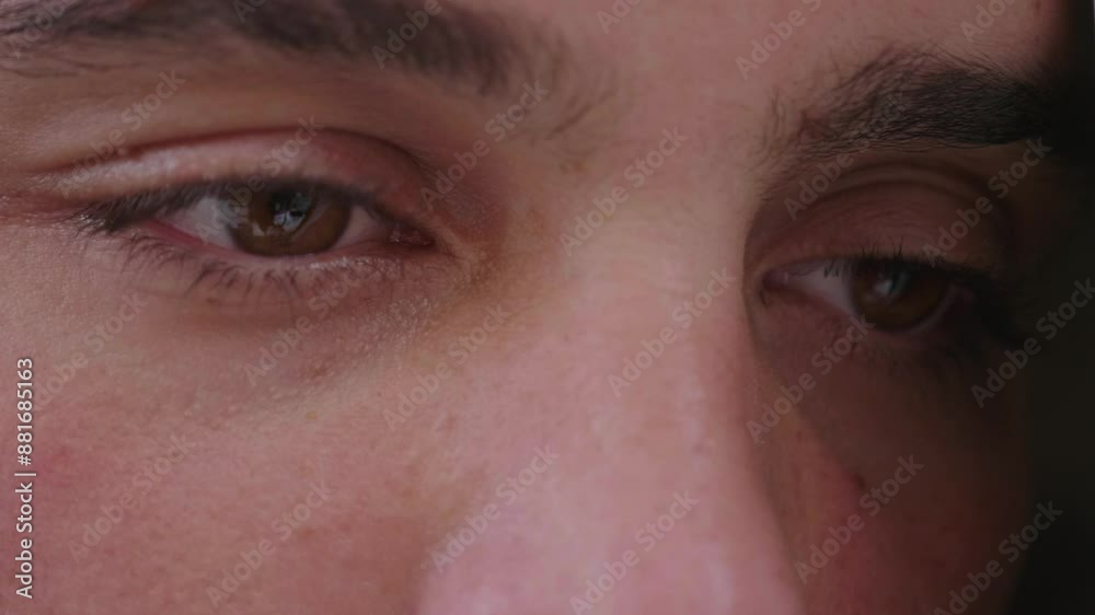 A close-up of a man with short dark hair and a beard, looking sad. His eyes reflect deep sadness and emotional pain. A close-up of a man with short dark hair and a beard, looking sad. His eyes reflect deep sadness and emotional pain.