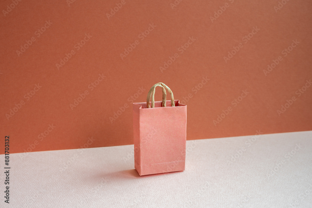 Paper shopping bag on pink and red background