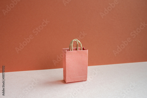 Paper shopping bag on pink and red background