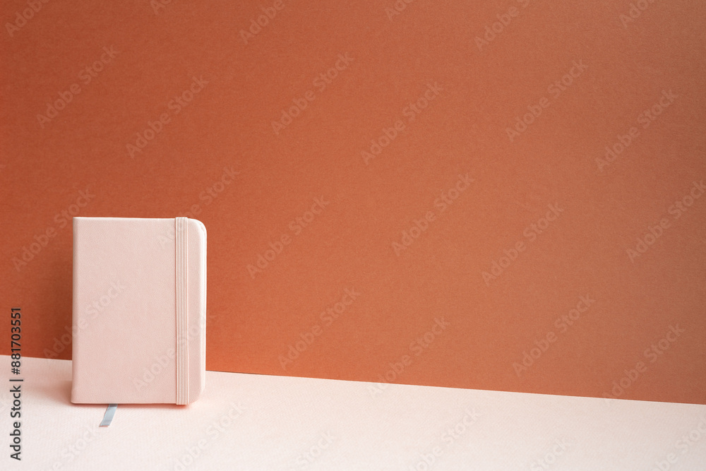Diary notebook on pink desk. red background