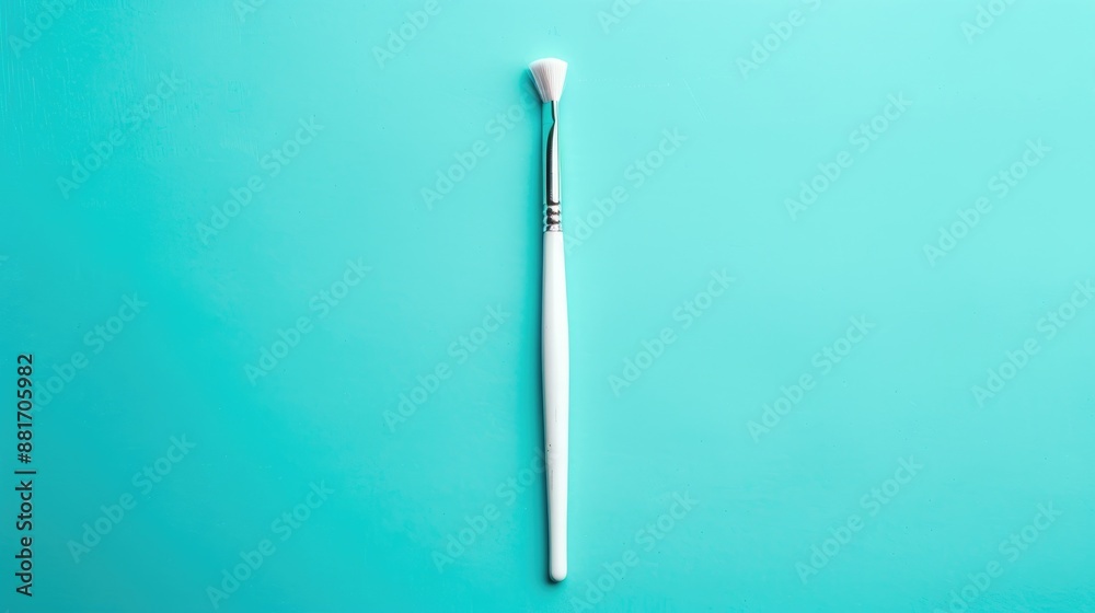 Minimalist white paint brush on turquoise background Minimalist white paint brush on turquoise background