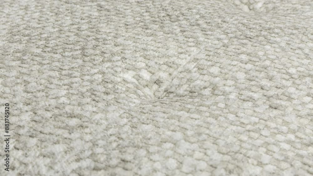 Camera slowly zooms in on fluffy wool texture on seat cushion in photography studio