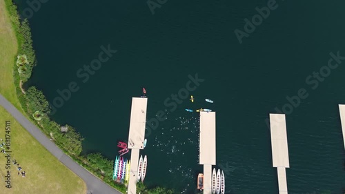 Top angle shot of Triathlon at Dorney lake, triathletes running on the track and swimming towards the transition area