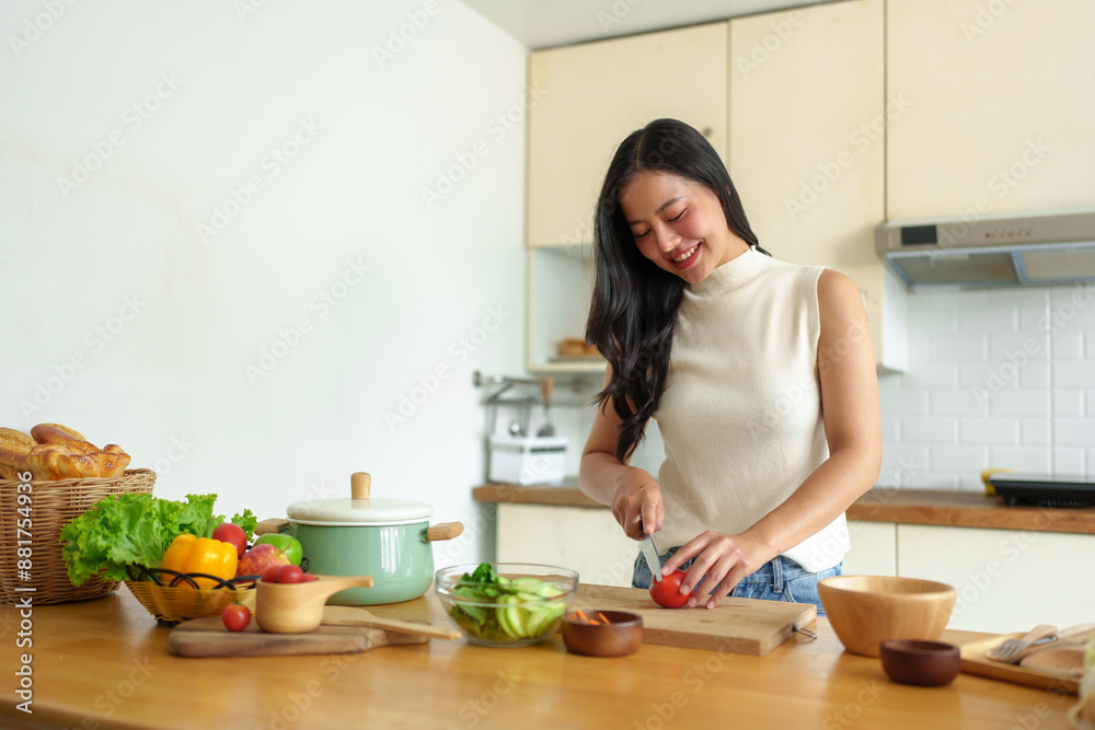 Diet to maintain figure. Fresh food is important for weight loss and perfect health. woman cutting vegetables Tomatoes into a bowl to make a salad to eat at home. Health care concept. Diet to maintain figure. Fresh food is important for weight loss and perfect health. woman cutting vegetables Tomatoes into a bowl to make a salad to eat at home. Health care concept.