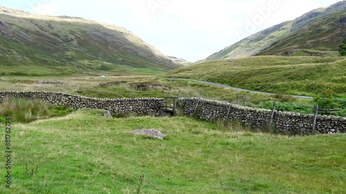 White car driving from Wrynose Pass in Duddon Valley, Lake District, England, UK. photo