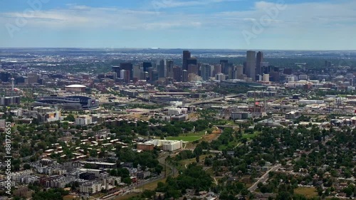 Summer downtown Denver Colorado aerial drone Mile High city skyscrapers neighborhood homes blue skies cloudy 6th avenue colfax RTD line front range foothills landscape backwards pan up reveal motion photo