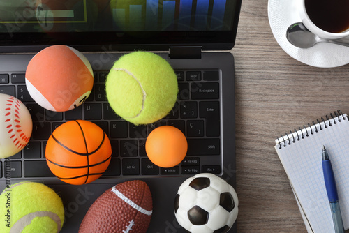 Fototapeta Naklejka Na Ścianę i Meble -  Entertainment with technology in sports with laptop and decoration balls