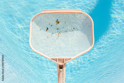 Close-up of a pool skimmer removing leaves from water
