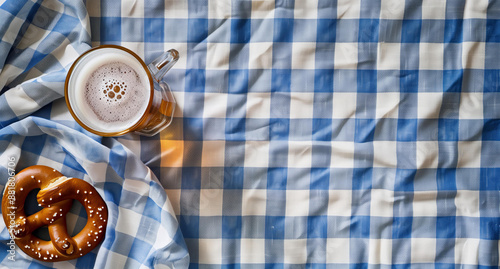  beer and pretzel on background, bavarian blue white pattern tablecloth, blank space for text, octoberfest