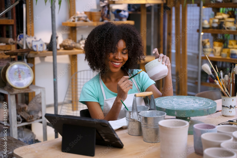 Young women is making earthenware at workshop. Young women is making earthenware at workshop.